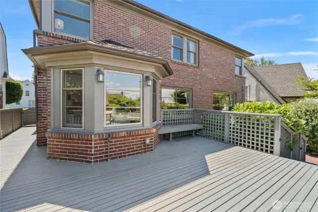 Deck wraps around side of the home and to the backyard.