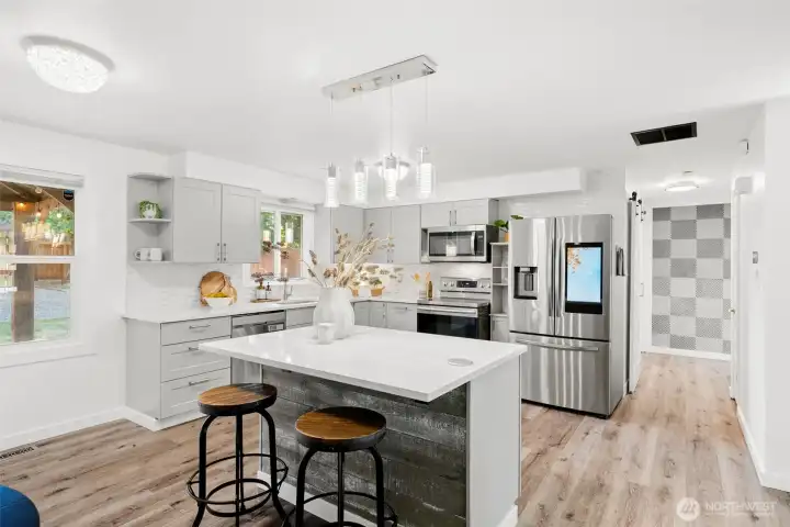 Newly remodeled kitchen with large counter and bar seating