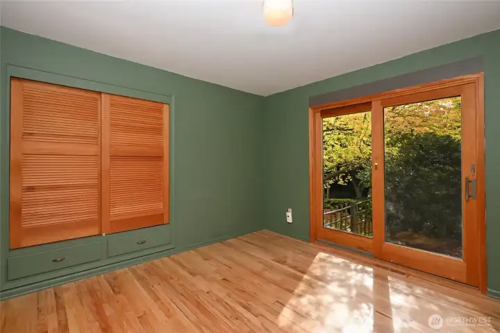 Second bedroom with sliding door to the back.