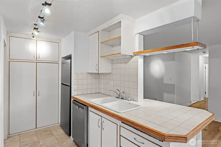 Bright, timeless white kitchen beautifully accented with warm wood tones for a classic, inviting look