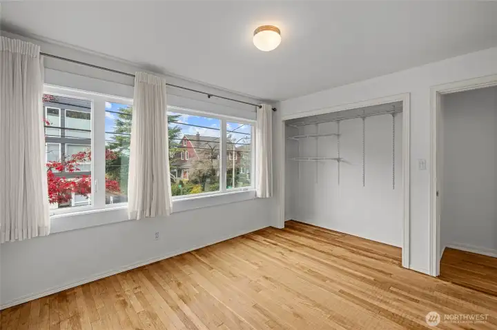 Spacious bedroom with oversized windows and effortless closet access.