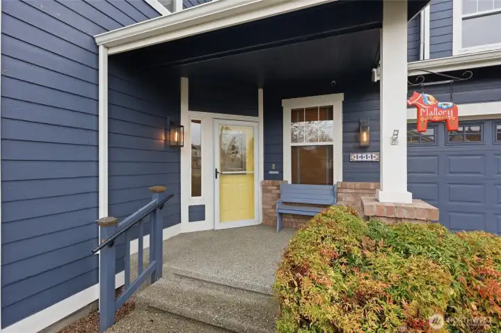 Lovely covered porch to enjoy your new community! Elegant front door with storm door.