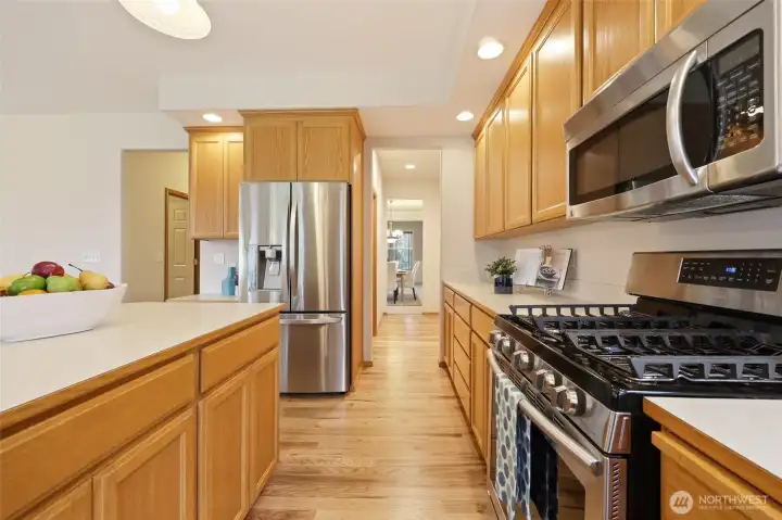 All stainless steel appliances including a gas stove, built in microwave, and very large fridge! Additional storage built in to the kitchen island as well! Finally a kitchen where you will never run out of space! This views shows through the butler's pantry and into the formal dining room.