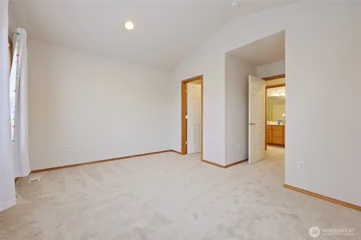 This bedroom includes a spacious walk-in closet, and right across the hall is the full bathroom.