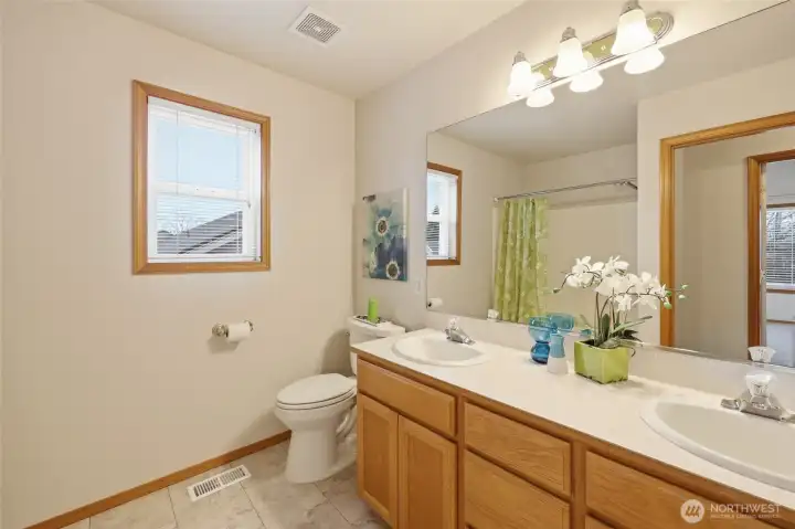 Full bathroom with double vanity offers the perfect space for busy mornings, guests, and more!