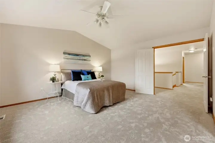 Vaulted ceilings and french doors add to the luxurious feel of this massive primary suite.