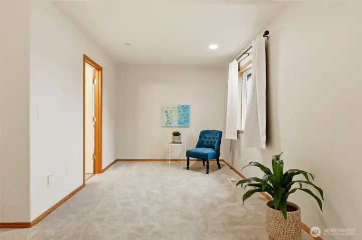 The primary suite also includes a thoughtful sitting area. Set up the recliner for a perfect book nook, or perhaps fill the space with a home gym!