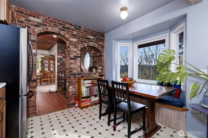 Open concept kitchen and dining area with large view window.
