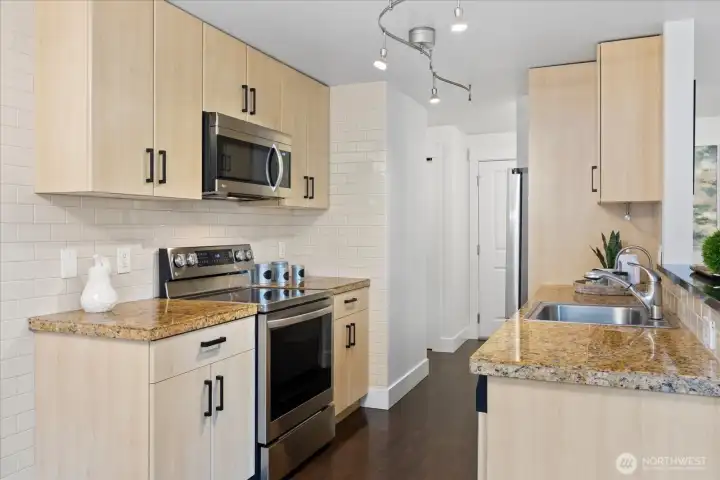 Pretty kitchen with newer frig installed in 2025.