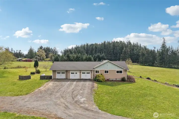 3 car garage with the furthest bay to the left being used for the workshop.