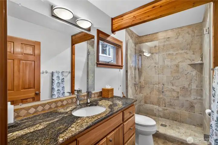 Main floor bath with granite, tiled & glass-in shower.
