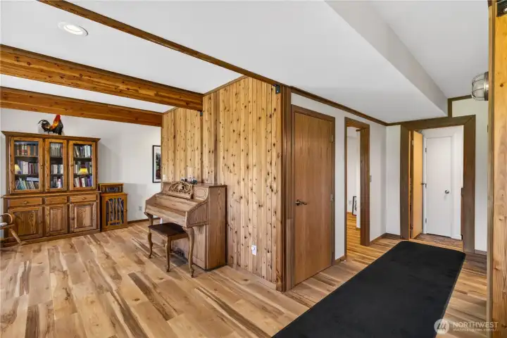 Hallway on lower level leads to "flex room," bath & laundry room.