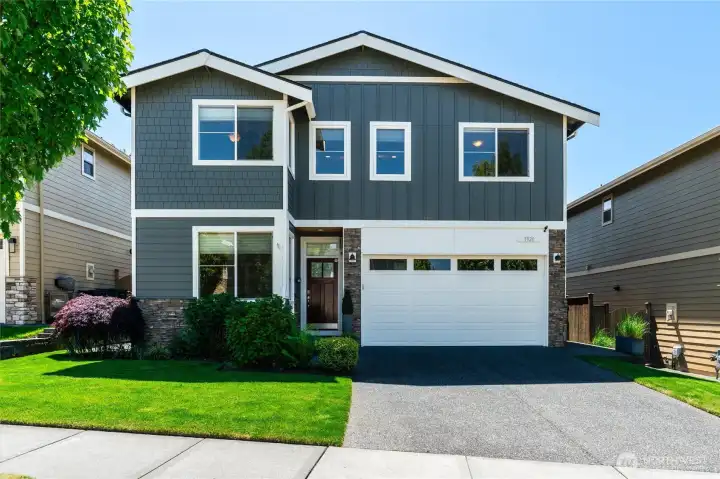 Pleasant curb appeal with a variety of siding treatments and brick accents offering a modern feel