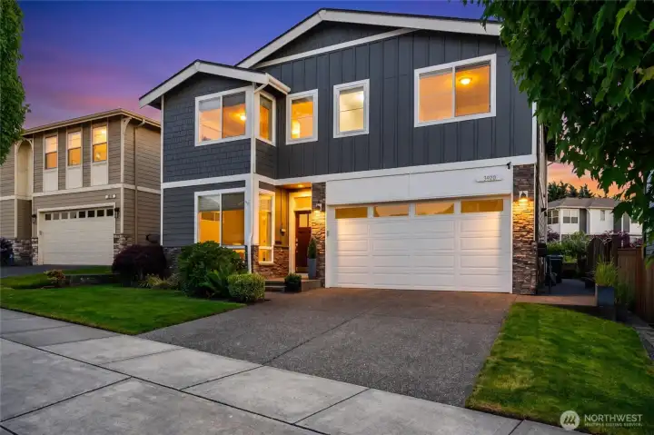 Manicured landscaping, clean roof lines, and large front windows offer an architecturally pleasing approach