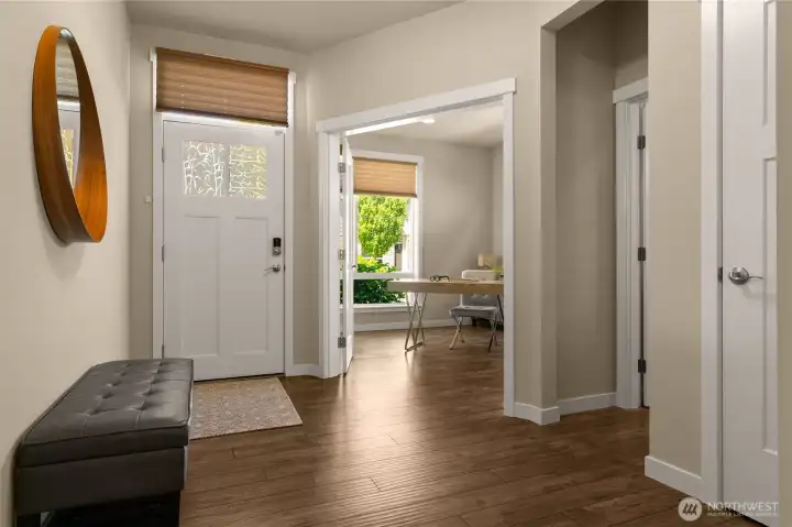 A welcoming sense of arrival with wide entryway for greeting guests and warm, wood-look laminate  flooring