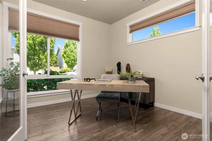 Elegant double glass doors lead into a bright, north-west facing main floor office that overlooks the neighborhood