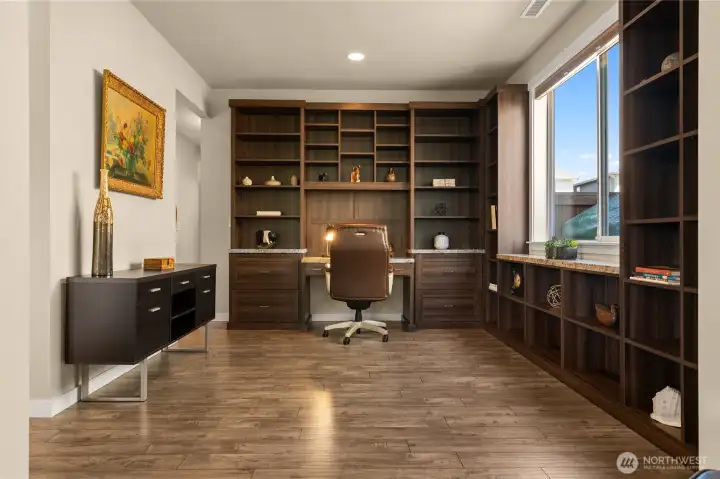 The versatile den or library features wrap-around bookshelves, making it ideal for avid readers and collectors, and serves as a secondary home office space
