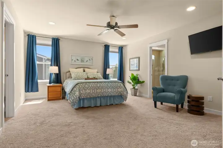 Double doors open to sizable primary suite with dual walk-in closets, custom built-ins, and luxurious bathroom