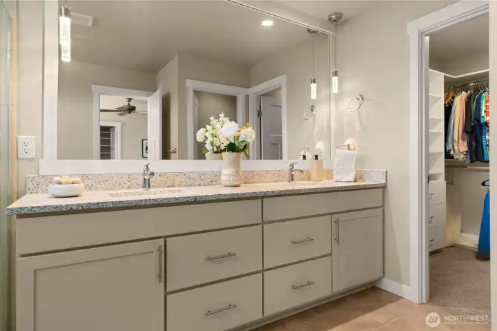 The extended primary bathroom vanity features dual sinks and ample storage for all your toiletries.