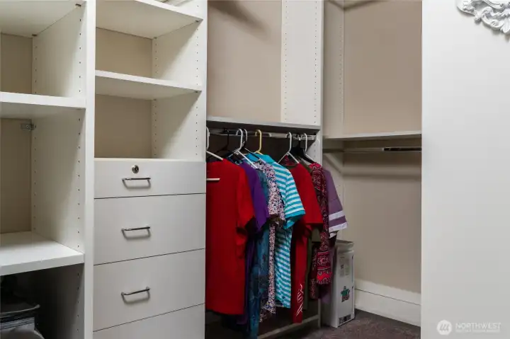 One of two primary bedroom walk-in closets with custom drawers, shelves and hanging options to stay organized