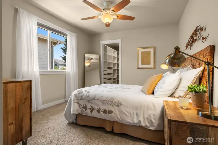 Secondary bedroom with ceiling fan and large walk-in closet easily accomodates queen bed plus dresser