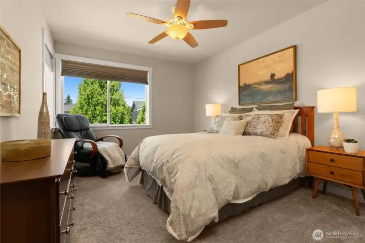 Secondary bedroom with pleasant birds-eye neighborhood views, offers a walk-in closet and easily accommodates a queen-sized bed and dresser