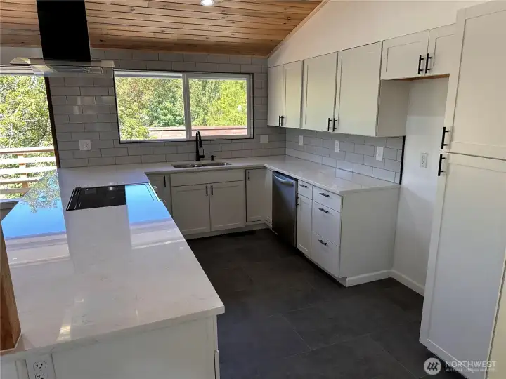 kitchen has new cabinets, quartz counters, tile and aappliances kitchen has new cabinets, quartz counters, tile and aappliances