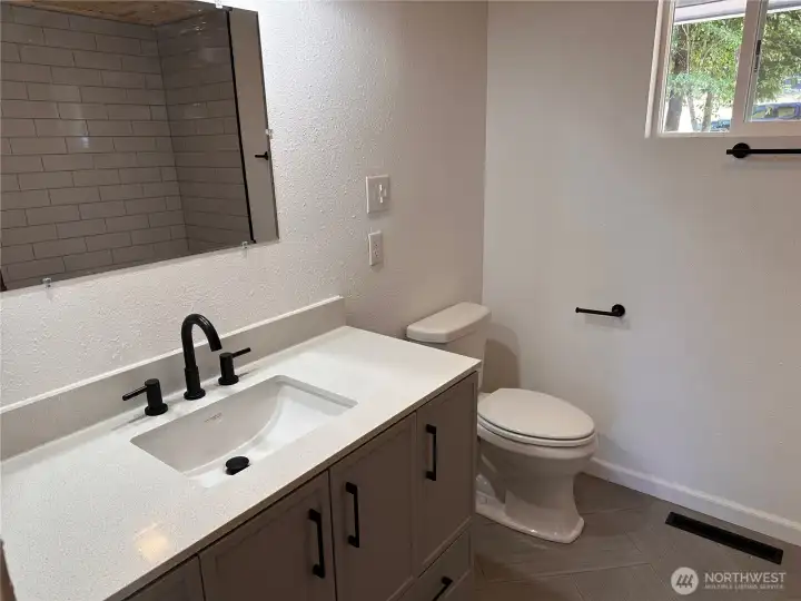 Main floor bathroom has new tile, vanity and fixtures Main floor bathroom has new tile, vanity and fixtures