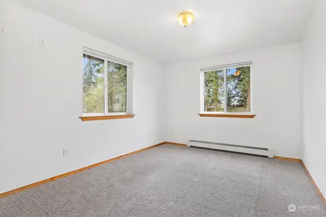 The primary bedroom looks to the rear and side yard and has brand new carpets.