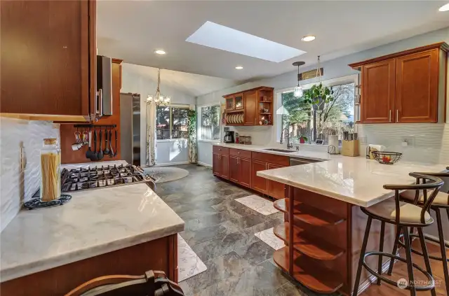 Lovely Natural Stone Countertops And A Peninsula For Extra Seating!