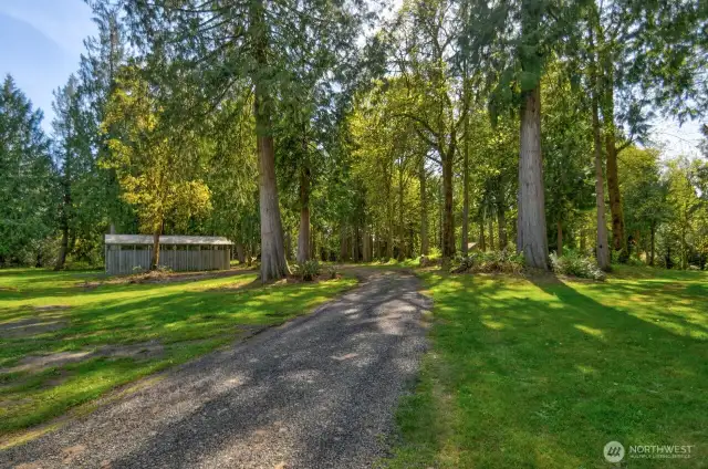 Gravel road leading to storage container/covered structure for boats, trailers, etc.