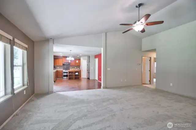 Living room showing dining/kitchen area and two bedrooms and full bathroom to the right.