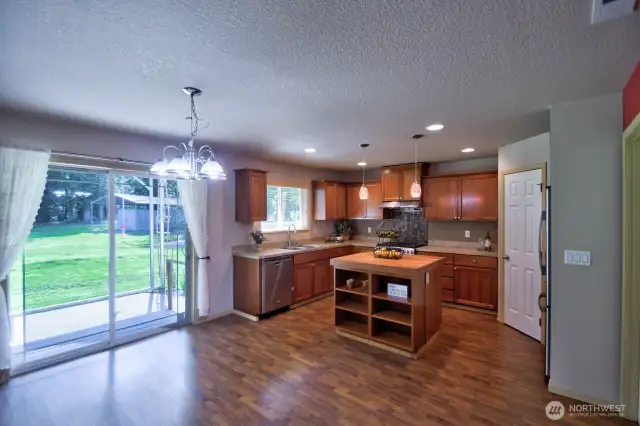 Amazing kitchen with dining area and glass slider leading to the covered patio and magnificent back yard.