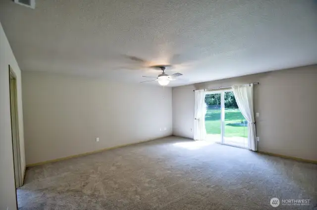 Very large primary bedroom with glass slider to covered back patio.
