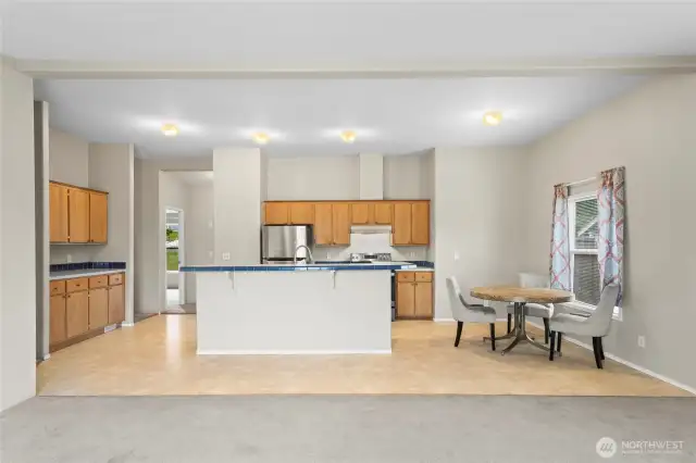 The kitchen has a perfectly quaint eat-in space for a smaller dining table and features great cabinet space for storage.