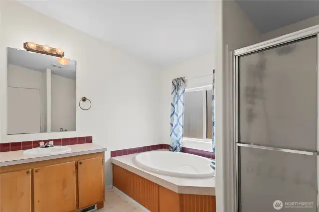 The 5-piece primary bath features a walk-in shower, oversized soaking tub and double vanity. A bit of paint and some updated fixtures will go a long way here!