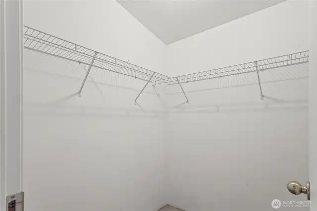 The primary walk-in closet is spacious and can fit even the most expansive wardrobe. Add in more shelving or built-ins for more organization and clever use of space.