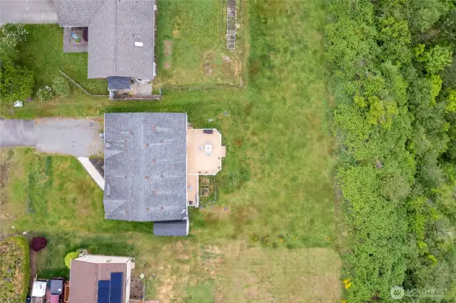 A bird's eye view really shows off all the best qualities of this lot: lush green yard, huge view deck and privacy from the greenbelt behind the home. No future neighbors here!