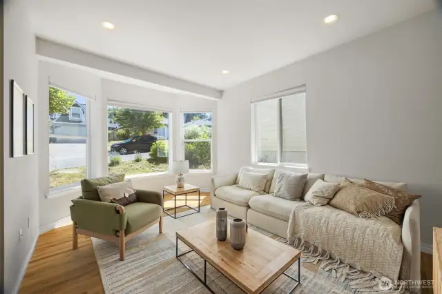 Another view of the living room and the large windows looking toward the street.
