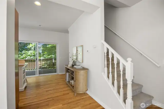 Looking from the living room toward the dining area that opens to the large deck beyond.