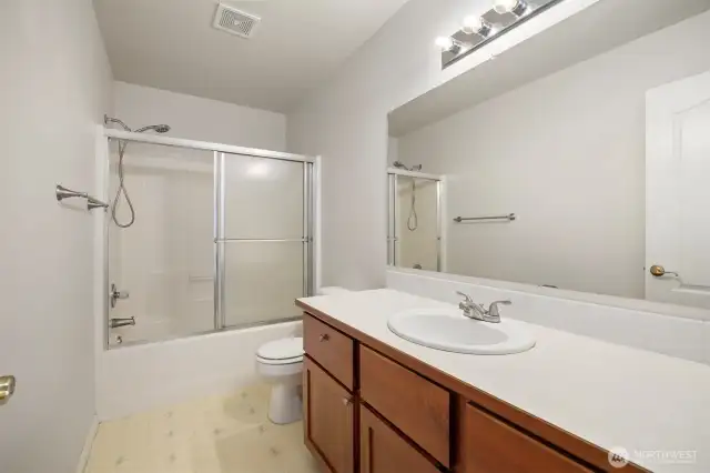 The full bath has a large single sink vanity.
