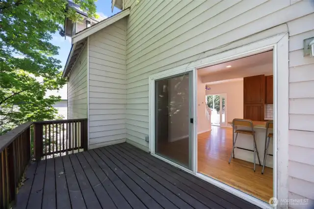 Looking from the deck toward the front entry beyond the kitchen and dining area.