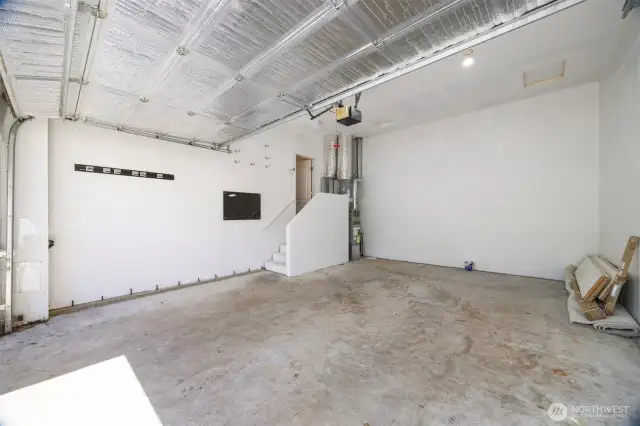 The garage is where the gas forced air furnace is tucked in beyond the stairway.