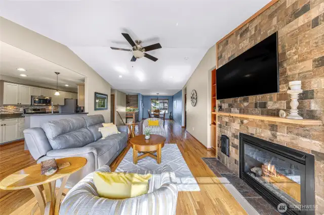 Another view down the length of the open-concept layout reveals the home’s airy design, tying together the kitchen, dining, and living zones with cohesive finishes and soft lighting.