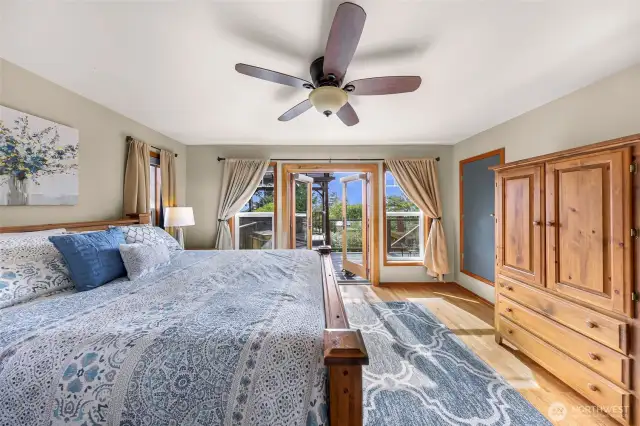 French doors lead from the primary suite to a private back deck, creating an effortless transition from rest to outdoor relaxation.