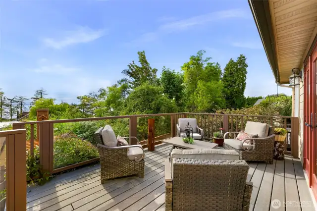 Relax or entertain on this expansive deck surrounded by nature. Comfortable seating and glass-panel railings offer seamless indoor-outdoor living.