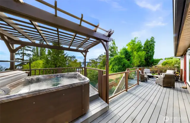 Enjoy sunset soaks in your private hot tub under a wood pergola, with filtered bay views and lush greenery creating a peaceful outdoor haven.