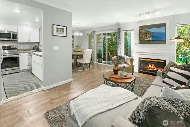 Bright and inviting living room with gas fireplace and tranquil greenbelt views - a rare find in Sundance at Klahanie.