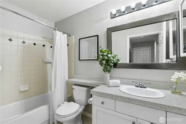 Clean, contemporary finishes with a wide vanity and extra counter space. Enjoy quality tile surround tub & shower, medicine cabinet and laminate flooring.