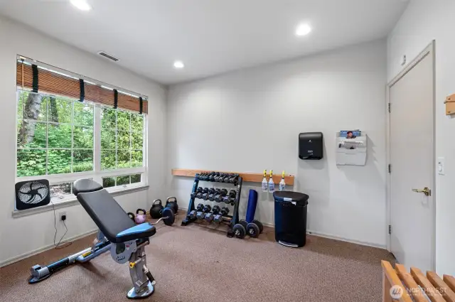 Well-equipped weight room with free weights, kettlebells, and resistance training equipment — all part of the resort-style amenities at Sundance at Klahanie.